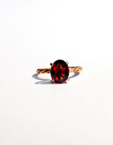 Red Garnet Gold Ring – Twisted Band Elegance